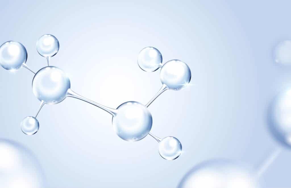 A digital illustration of interconnected clear spheres representing molecules, against a soft blue background, emphasizing a scientific and clean aesthetic.